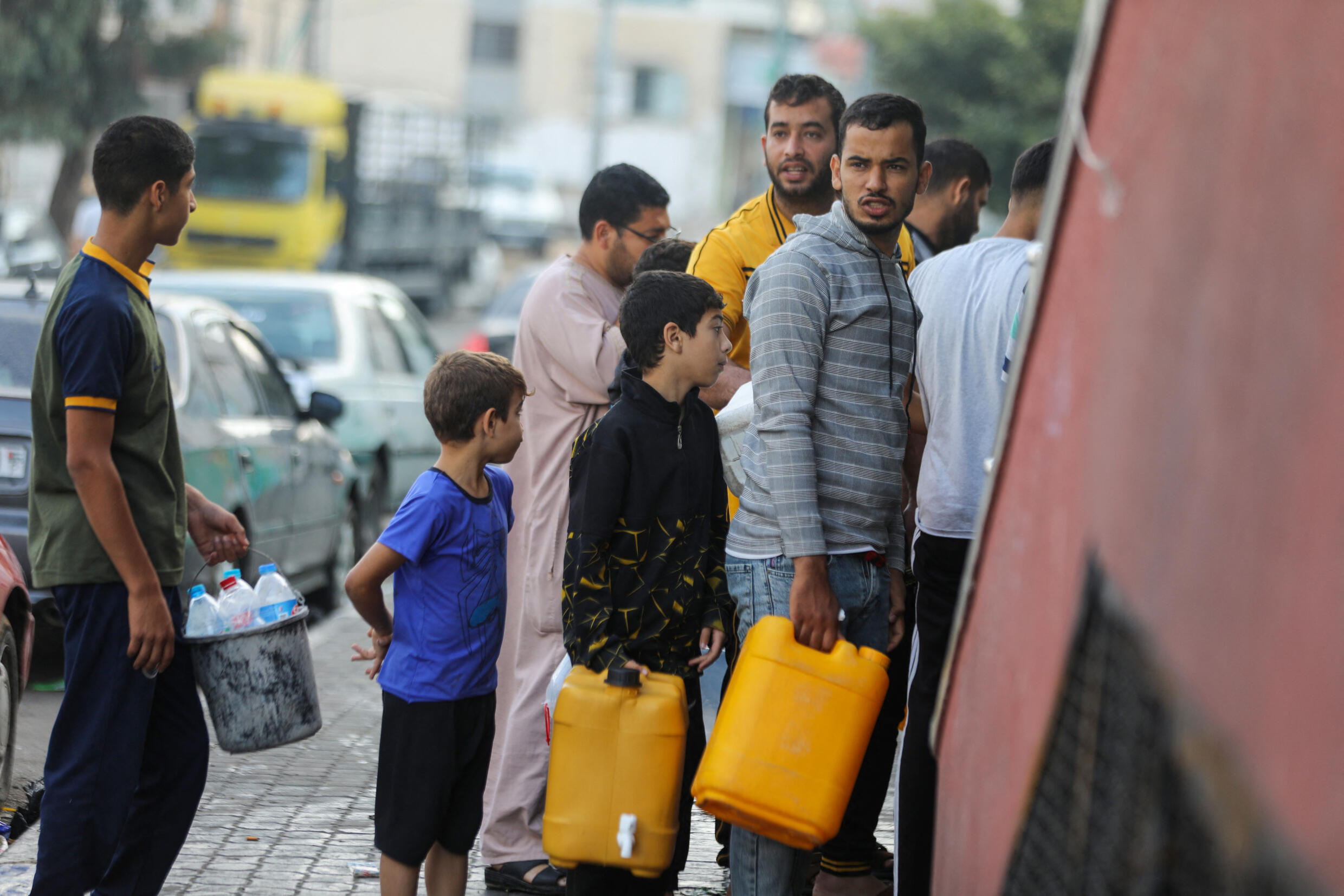 Palestinians line up to fill water canisters in Gaza City on October 16, 2023.